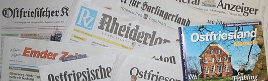 Ganz viele Zeitungen liegen verstreut über das ganze Bild. 